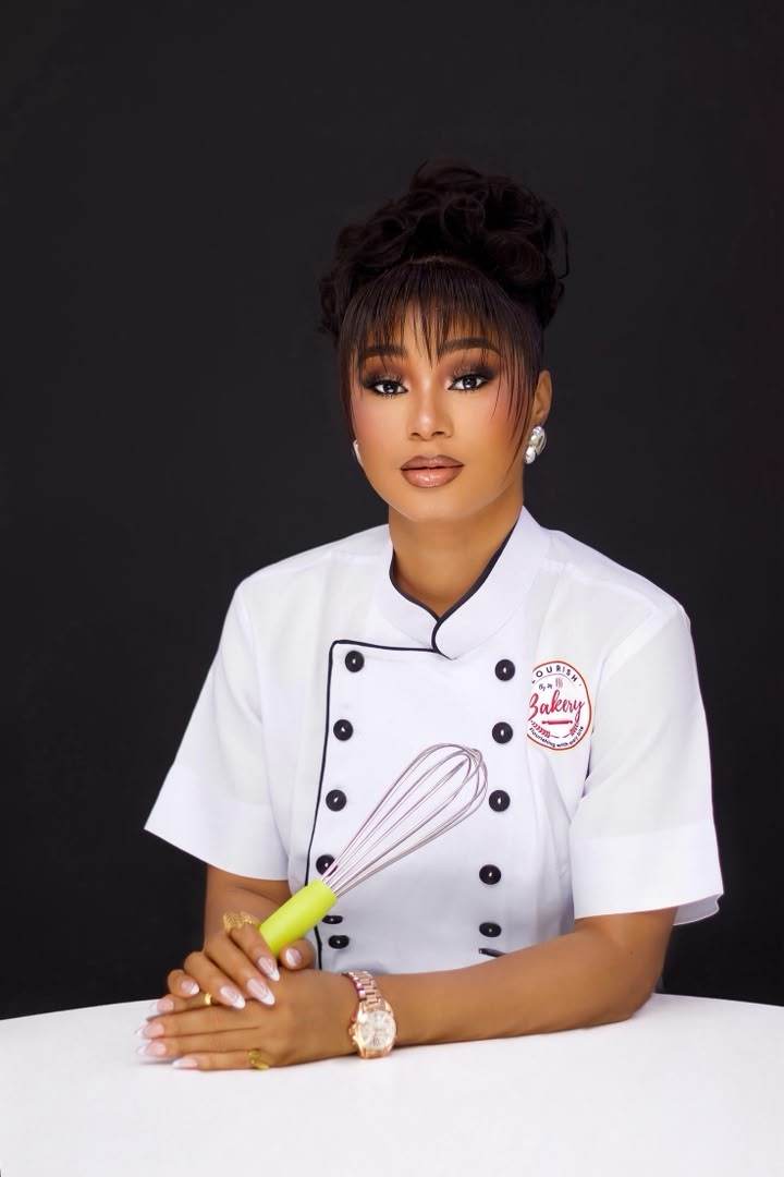 Bakery owner portrait in chef whites holding a whisk