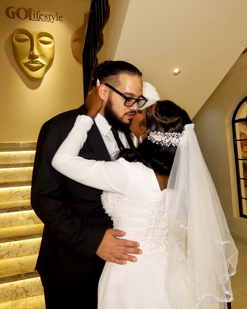 Bride and groom embracing on a staircase at GOLifestyle House